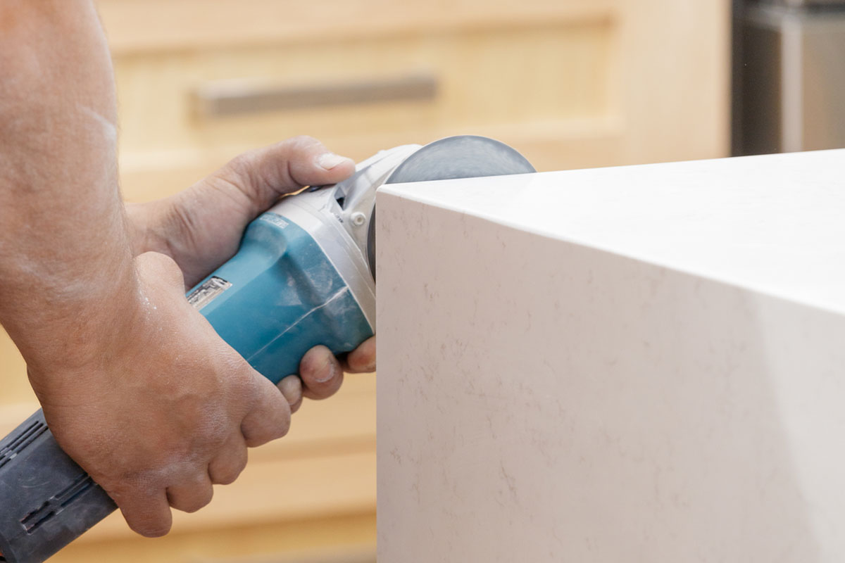 Man sanding marble end table